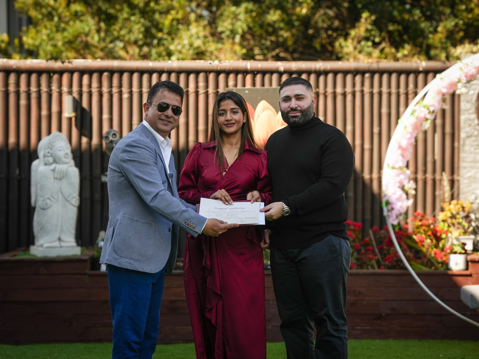 Star Celebrant presenting the marriage certificate to a couple after their garden wedding ceremony in the Hills District, Sydney