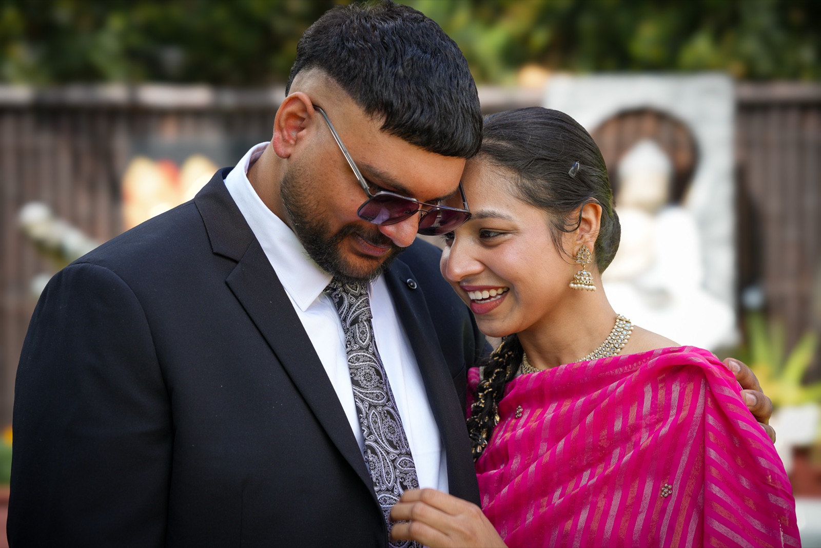 Gurpreet and Harpreet laughing together, her head resting against his, at their Punjabi backyard wedding in Sydney