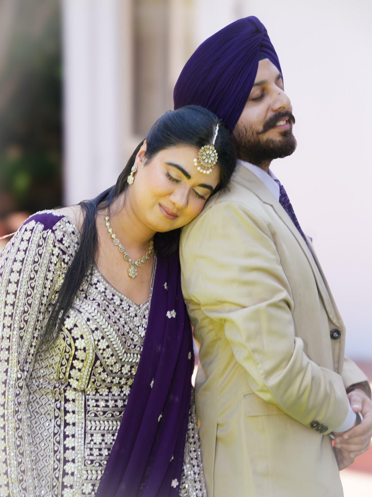 Jashandeep resting her head on Kanwarpal's shoulder in a quiet moment at their Sydney garden wedding