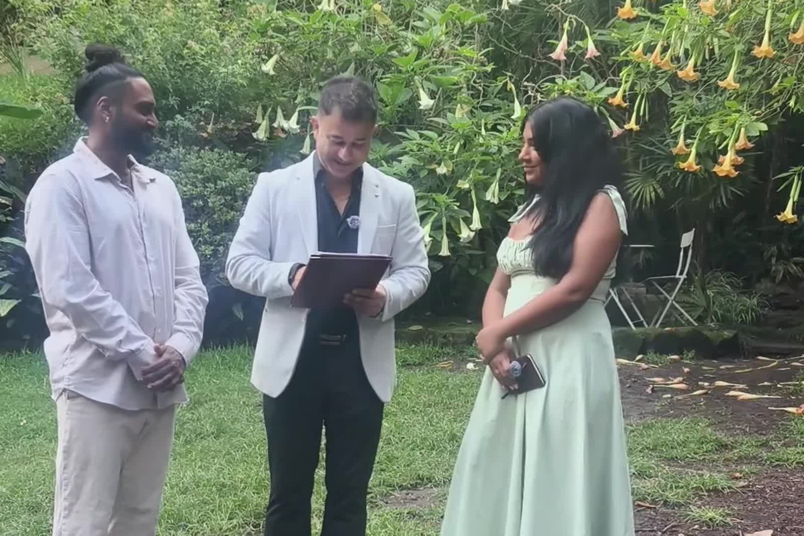Karthik and Sivai with their celebrant at their 7am wedding ceremony in Wendy Whiteley's Secret Garden, Lavender Bay, Sydney