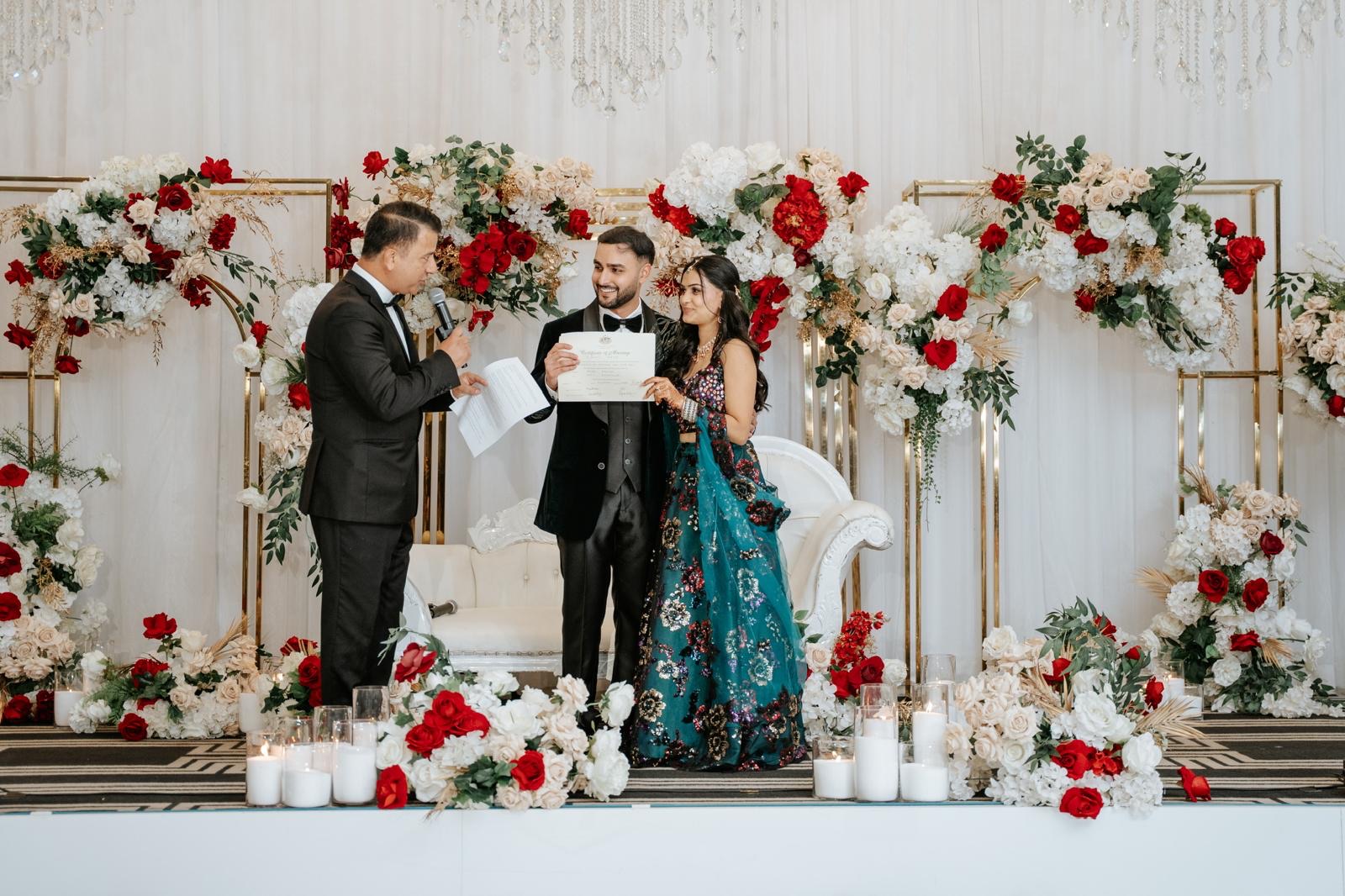 Star Celebrant presenting Aryan and Kriti with their marriage certificate during their Sydney wedding reception