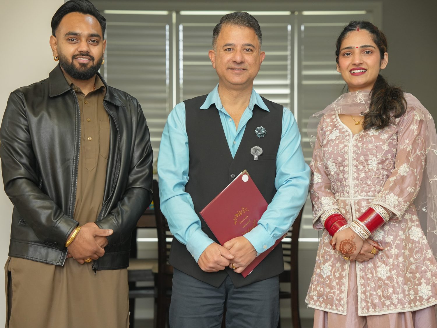 Sydney celebrant Rohit Revo presenting the marriage certificate to Lakhwinder and Harpreet at their legals-only home ceremony in Bella Vista