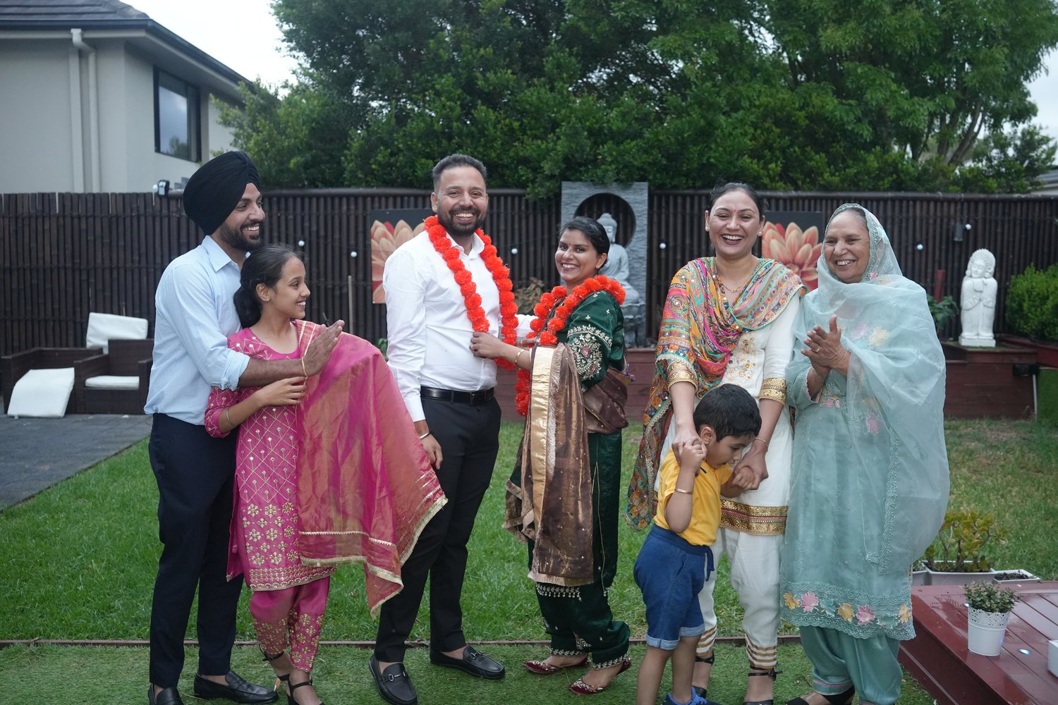A Punjabi family celebrating together at a garden wedding ceremony in Sydney