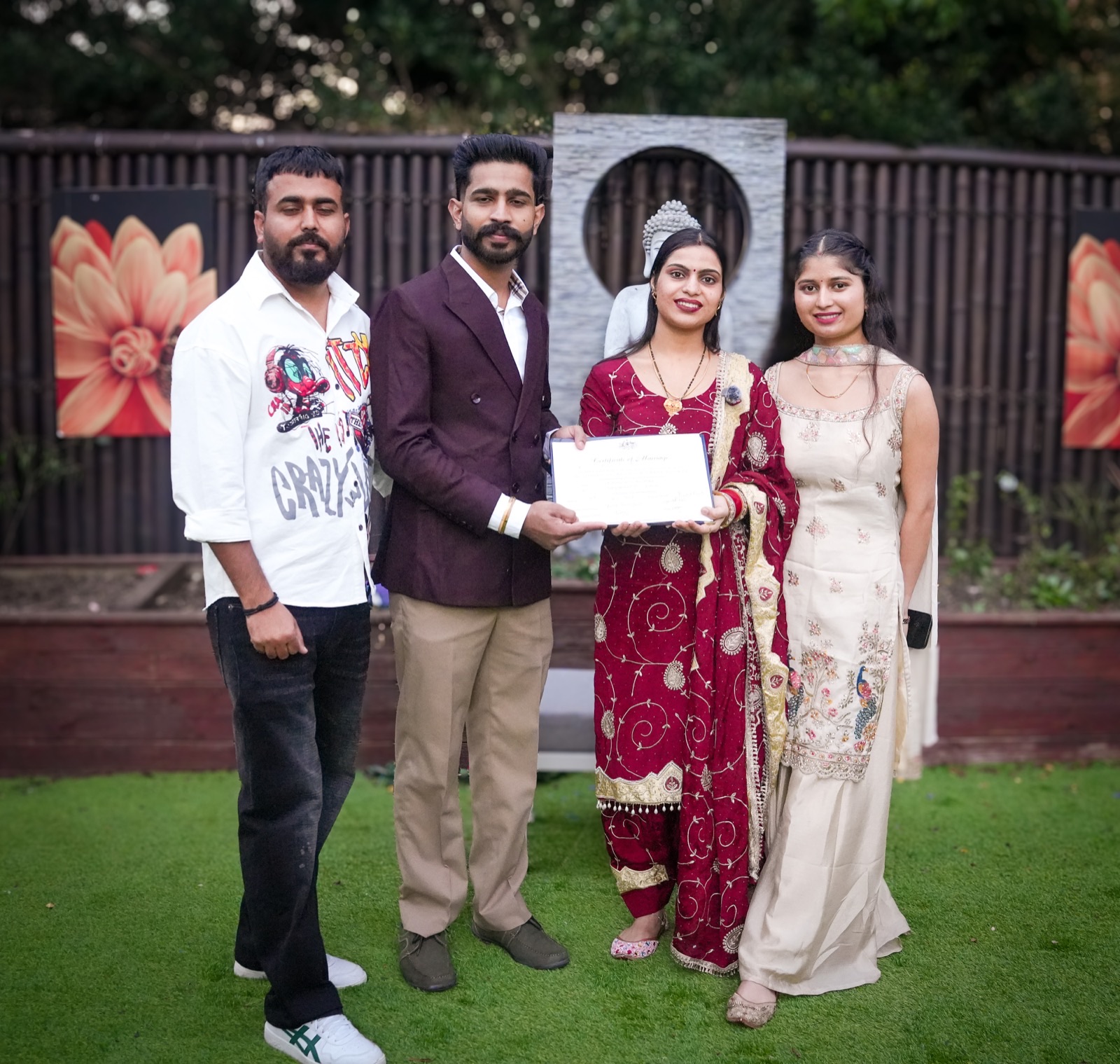Prince and Sagandeep holding their marriage certificate with their closest friends after their Sydney elopement