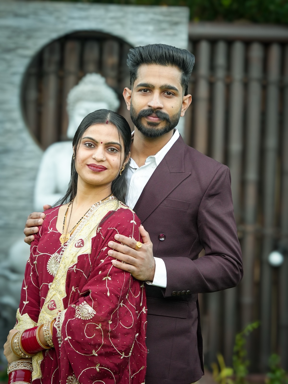 Sagandeep with her arms around Prince in front of the garden Buddha at their Sydney elopement