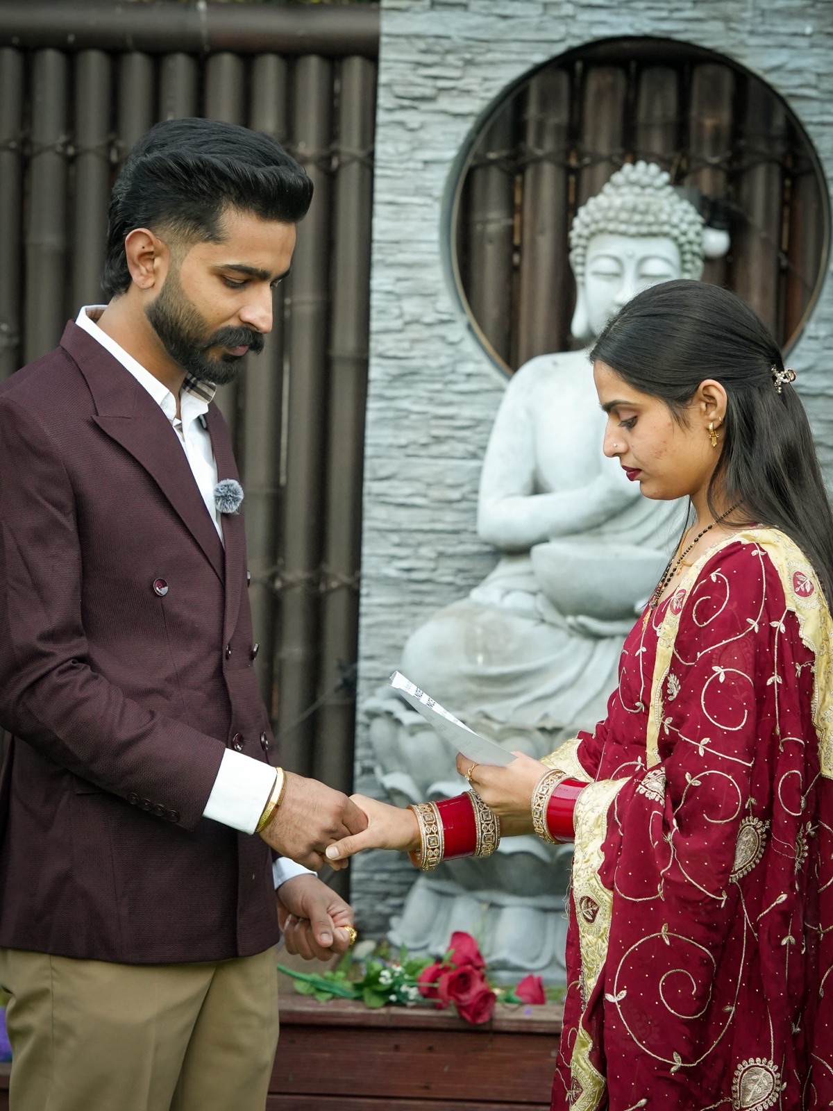 Prince placing a ring on Sagandeep's hand at their intimate backyard wedding in Sydney