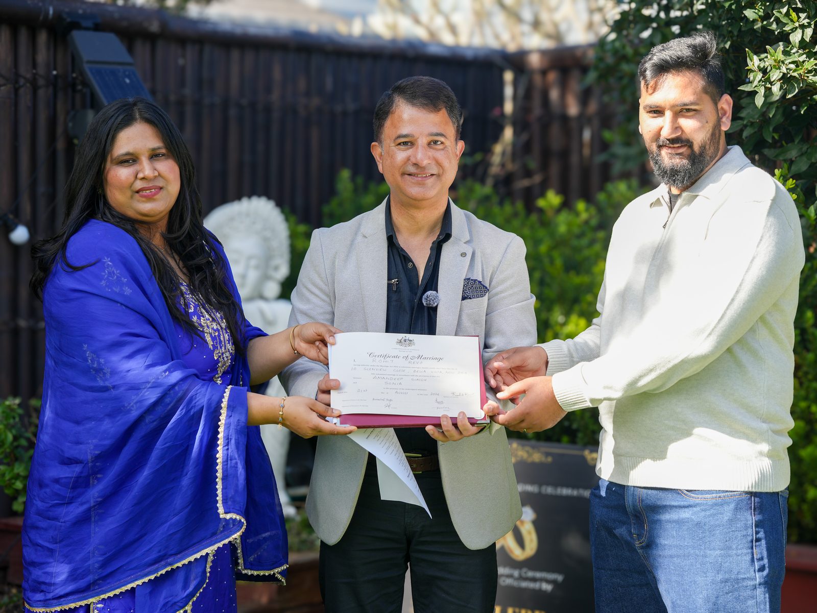 Rohit Revo presenting Amandeep and Sonia with their marriage certificate at their Sydney garden wedding