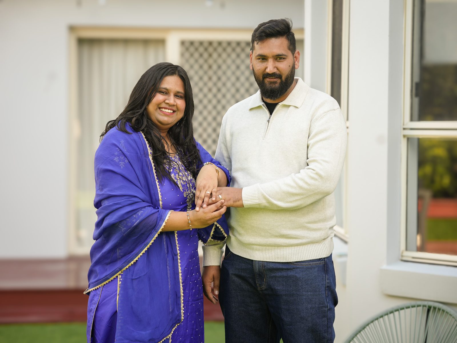 Amandeep and Sonia smiling together at their intimate Punjabi garden wedding in Sydney