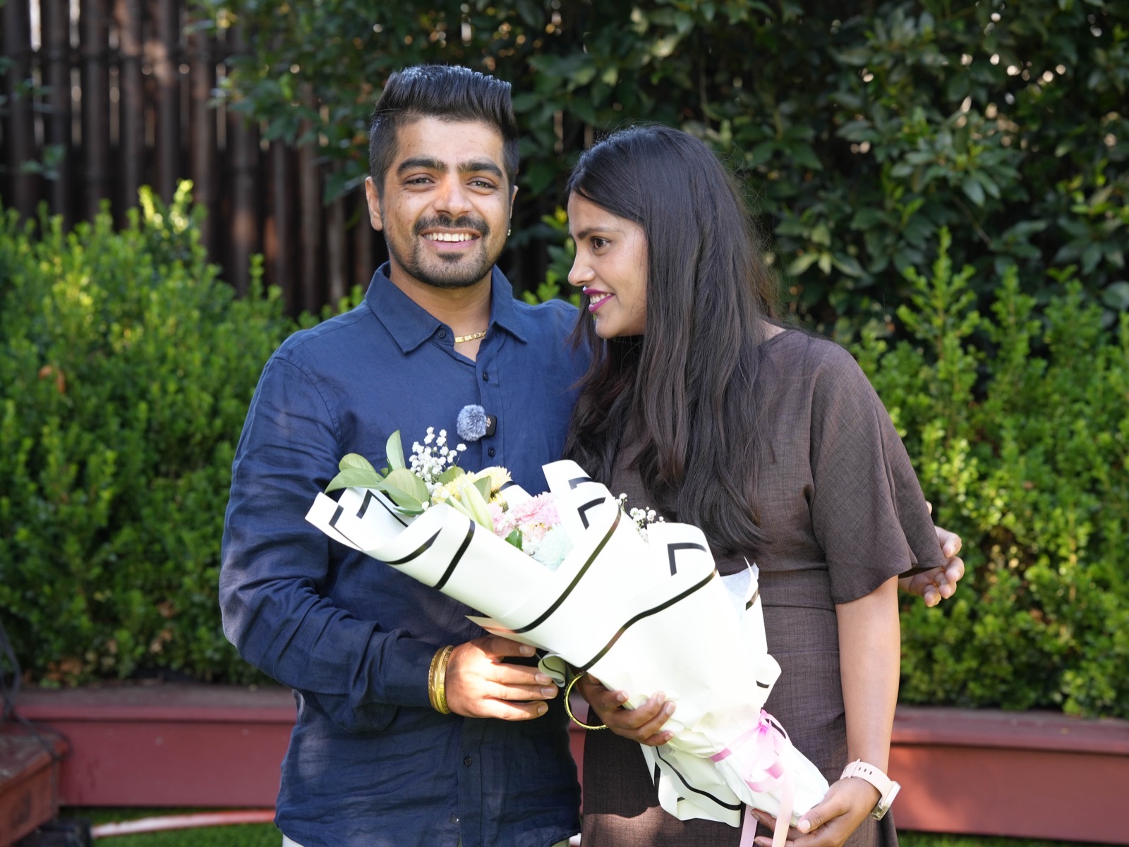 Sahil and Radhika sharing a happy moment with a bouquet at their Sydney wedding