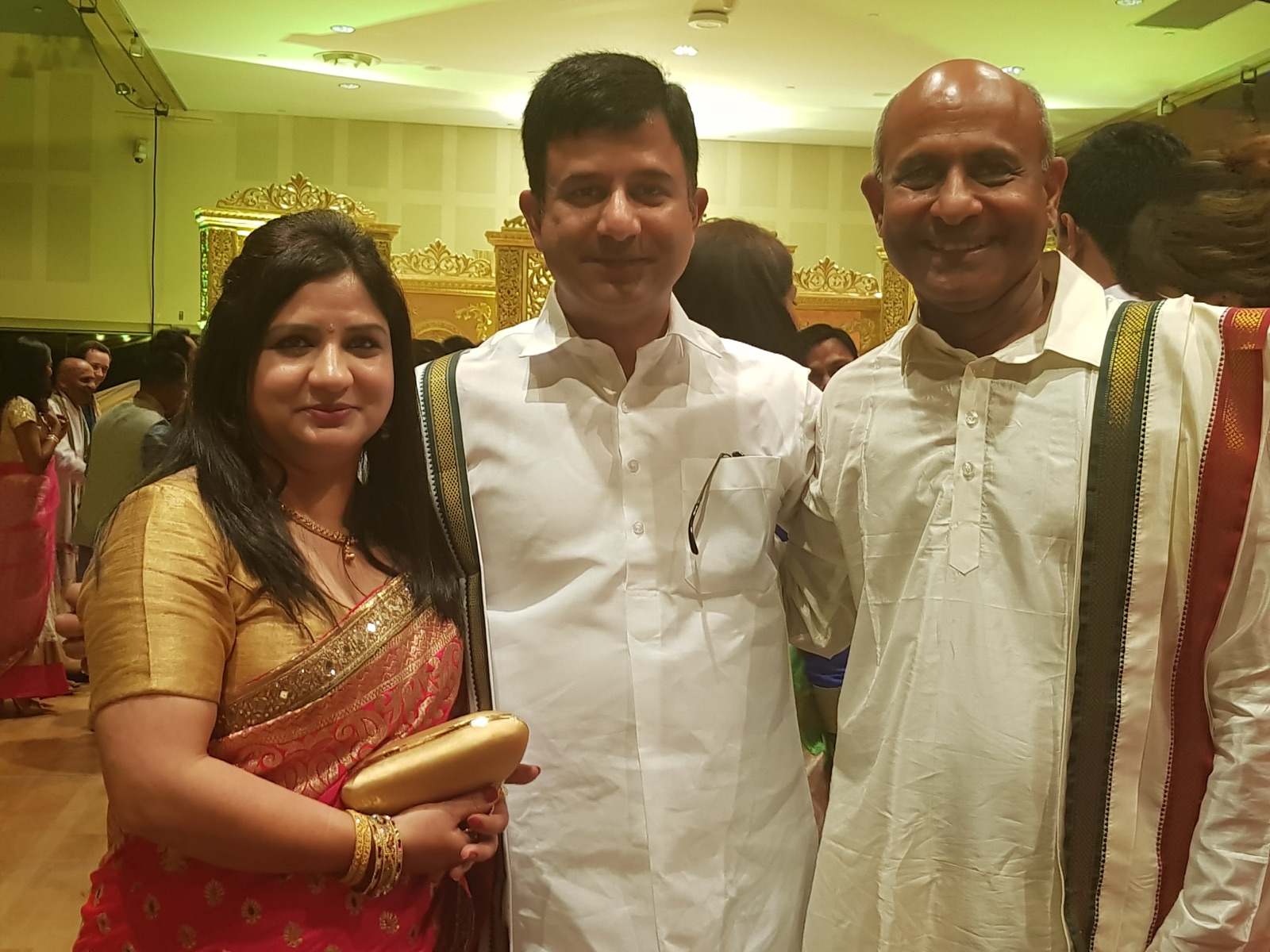 Rohit Revo and his wife with the bride's father, both men in traditional South Indian attire, at the Rosehill wedding in 2017