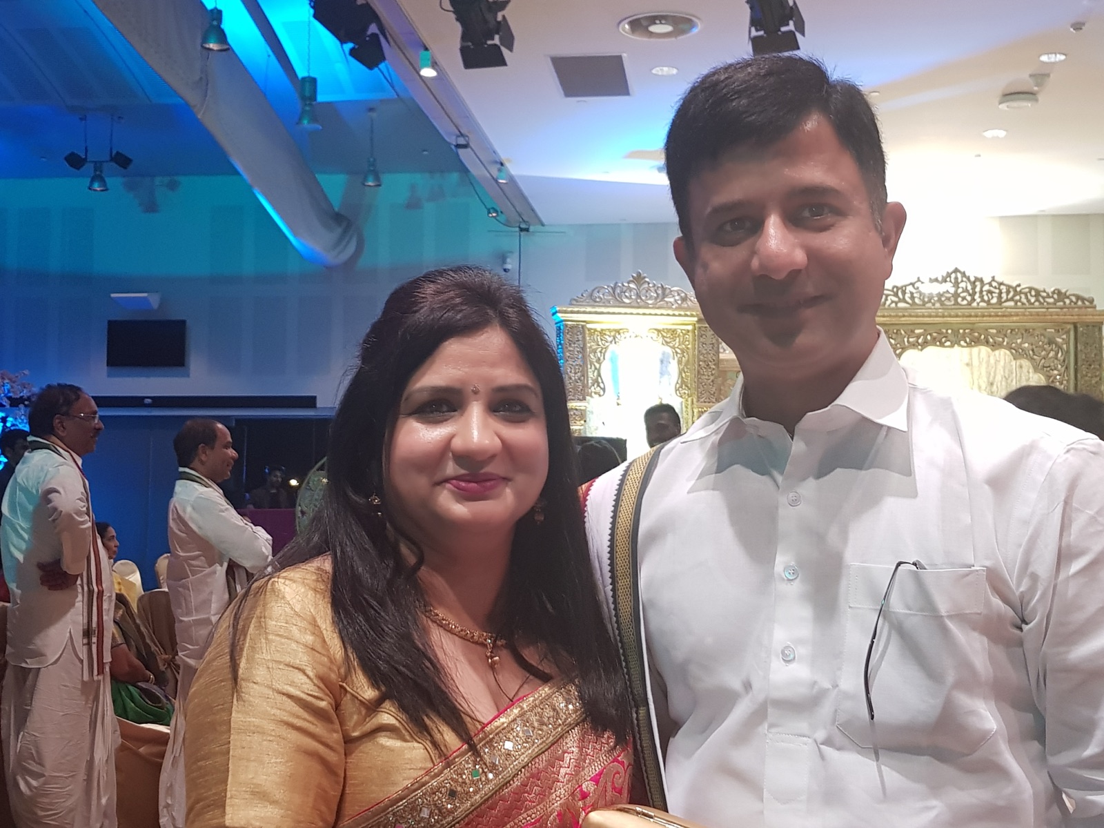 Rohit Revo in a South Indian white dhoti and gold-bordered angavastram with his wife at a 400-guest wedding reception at Rosehill Racecourse, 2017