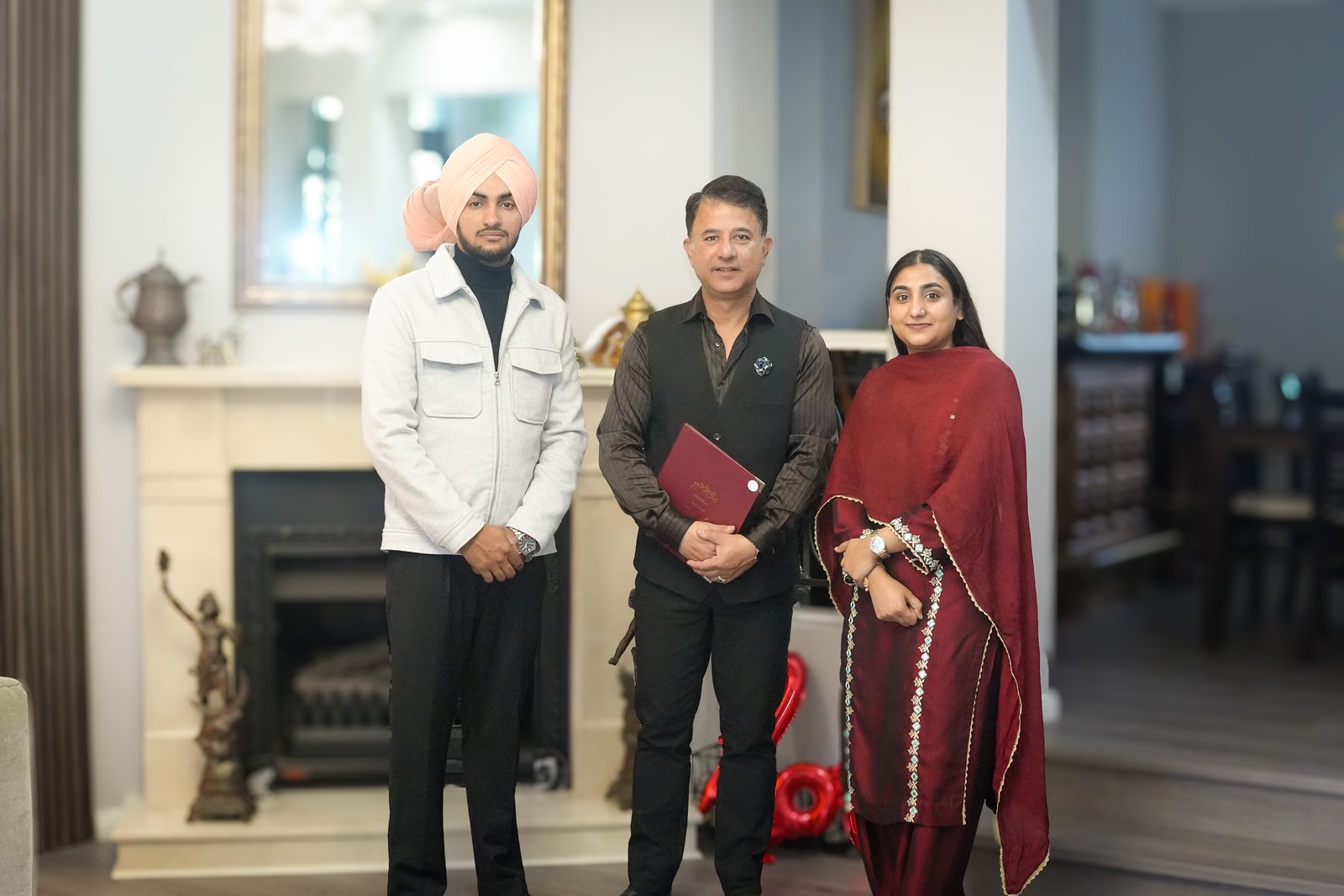 Rohit Revo standing with Inder and Anchaldeep and their marriage certificate after their court marriage in Sydney