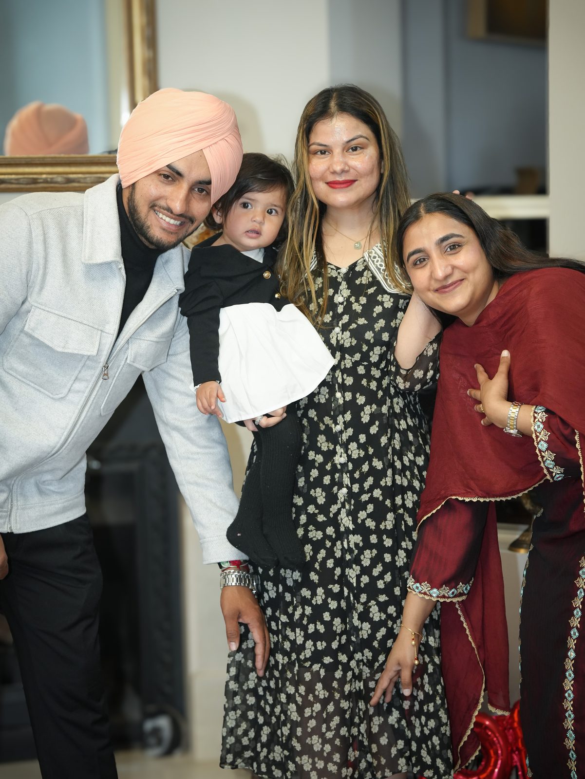 A joyful candid of Inder, Anchaldeep and family with a young child at their Sydney court marriage