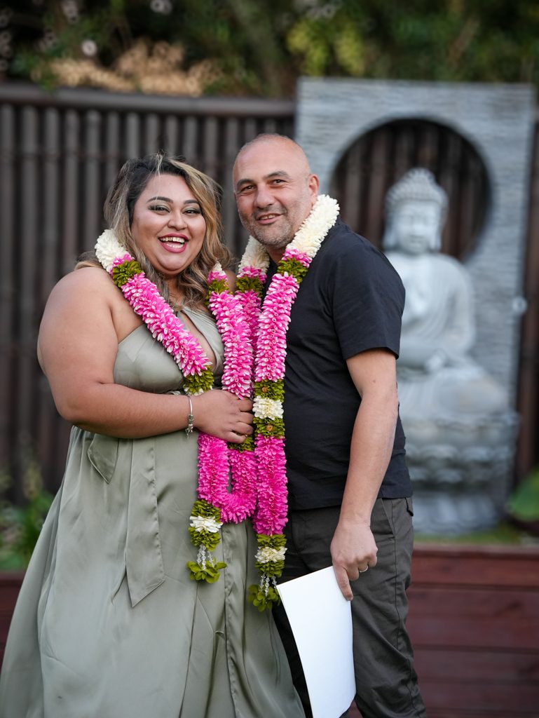 Couple exchanging flower garlands at a multicultural wedding ceremony in Sydney