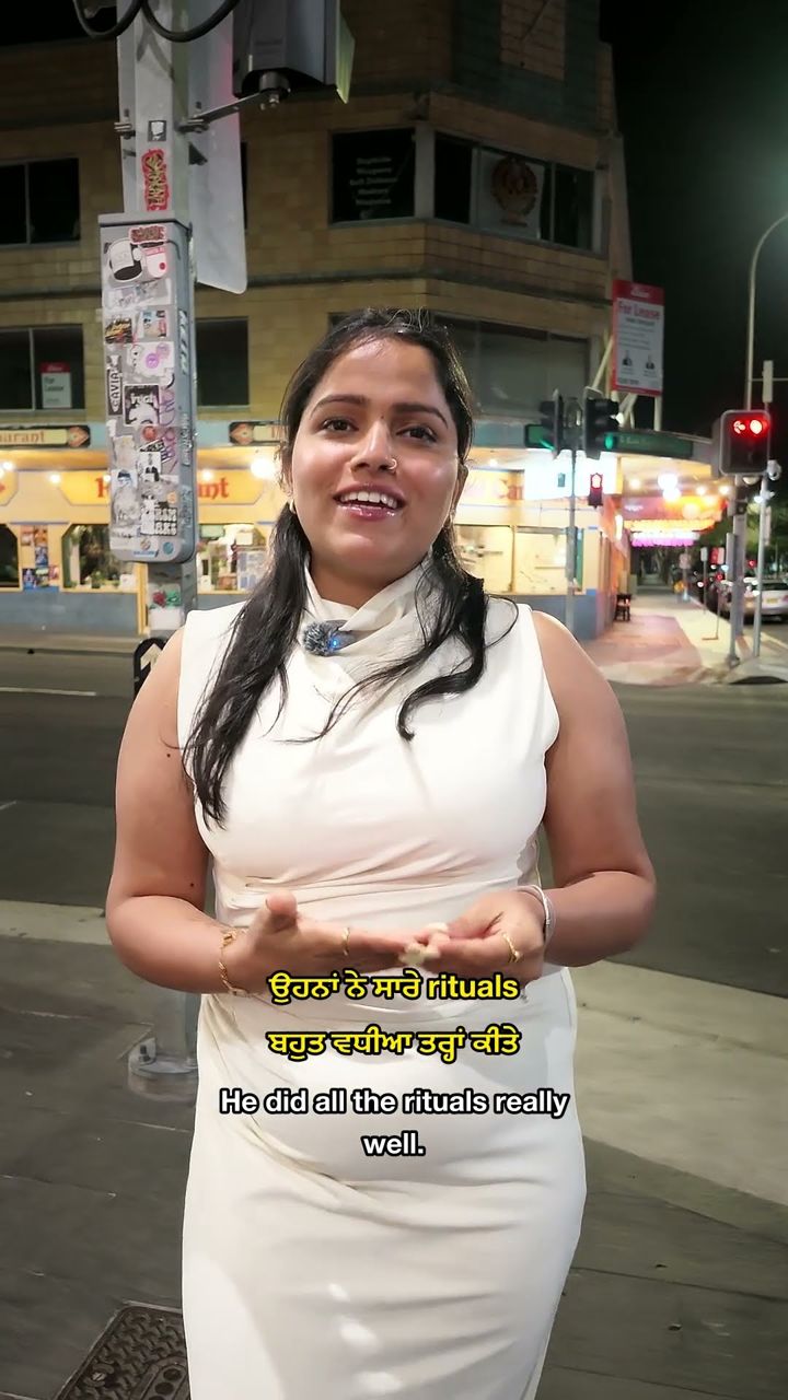 A guest speaking to camera outside the restaurant after Lovepreet and Gurpinder's Wollongong lighthouse wedding